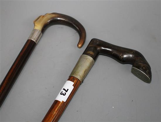 An Edwardian oak walking stick with pewter mounted horn horse hoof handle, 84cm and an ebony walking stick with silver banded horn hand